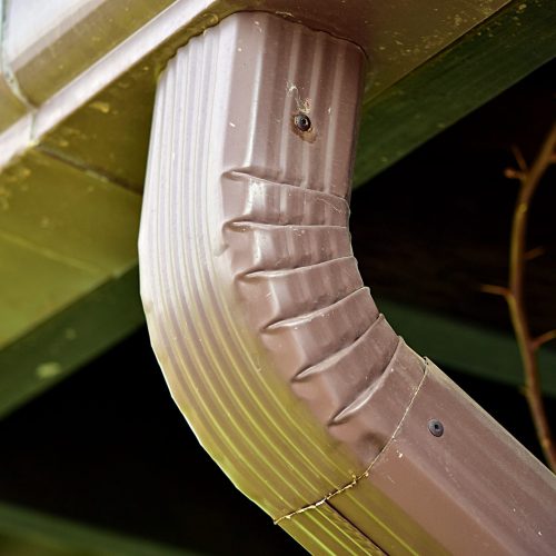 An elbow connection between a rain spout and the down spout.